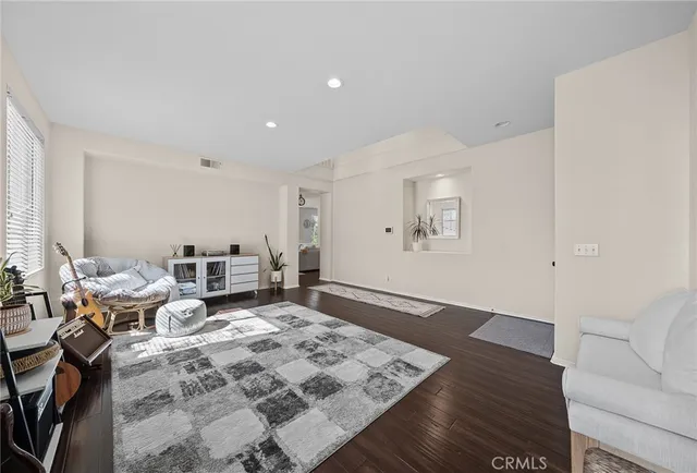 a living room with furniture large window and a table