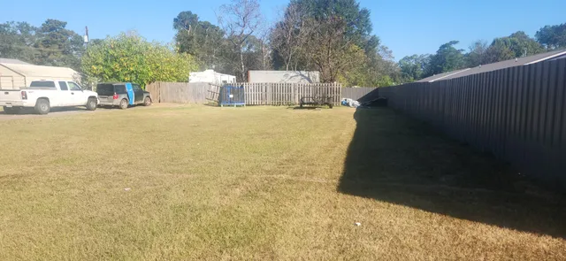 a car parked in front of a house with a yard