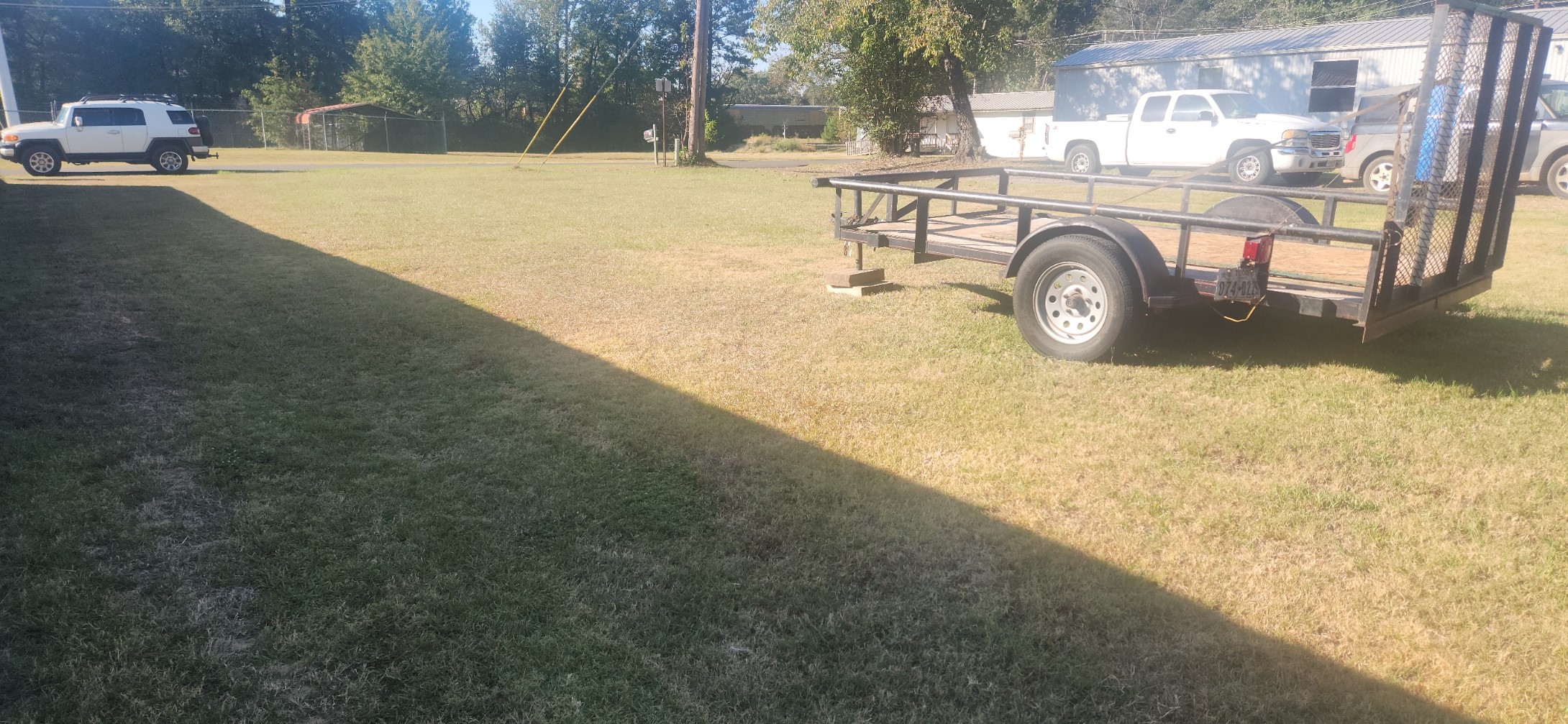 405 East Webster Street Jefferson, TX 75657 - Photo 2 of 3 a car parked in front of a house with a yard