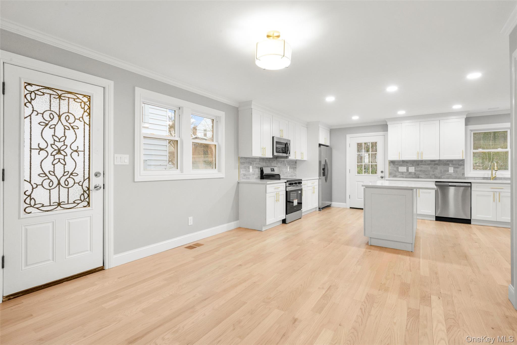 26 Ashton Road Yonkers, NY 10705 - Photo 13 of 33 a large kitchen with stainless steel appliances granite countertop a stove a sink dishwasher and a refrigerator with wooden floor
