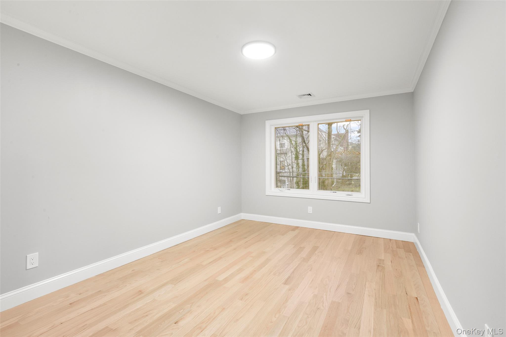 26 Ashton Road Yonkers, NY 10705 - Photo 24 of 33 an empty room with wooden floor and windows