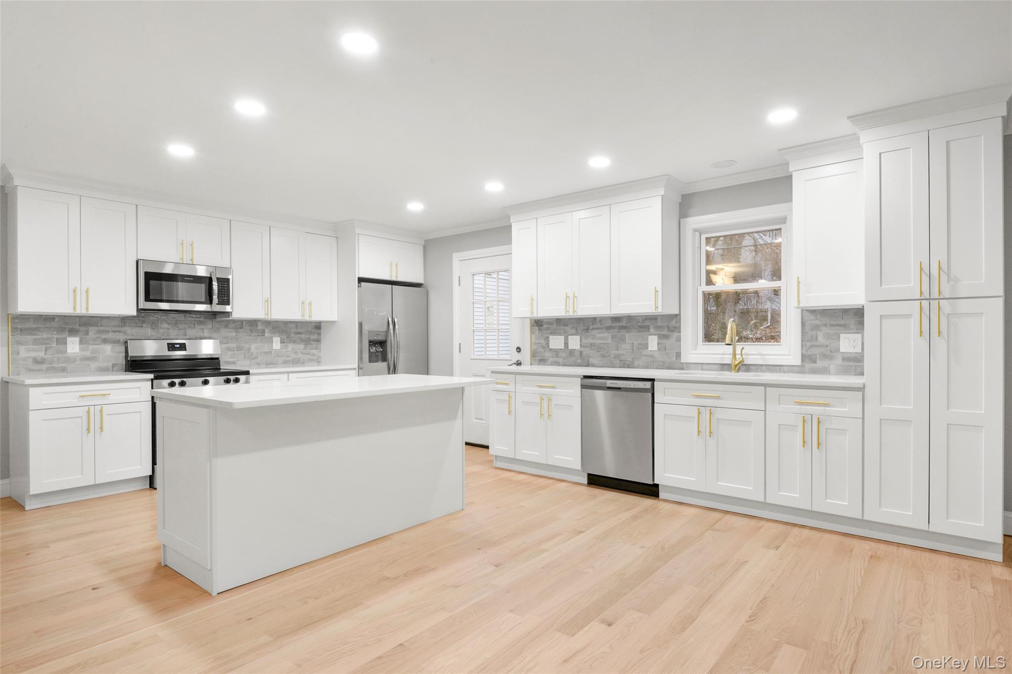 26 Ashton Road Yonkers, NY 10705 - Photo 3 of 33 a kitchen with granite countertop white cabinets and white appliances