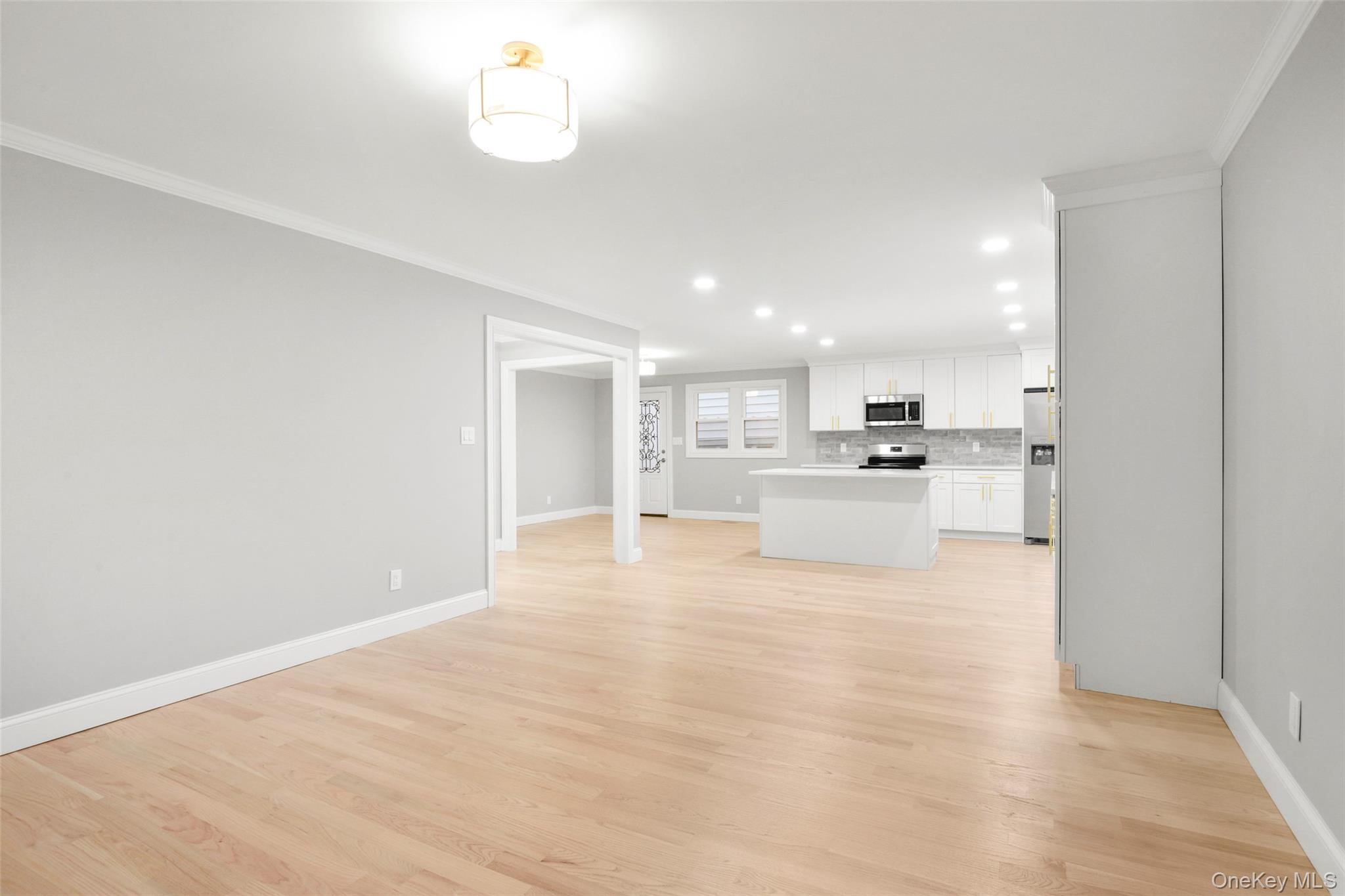 26 Ashton Road Yonkers, NY 10705 - Photo 8 of 33 a view of kitchen with kitchen island white cabinets and refrigerator