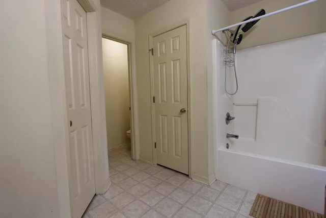 a bathroom with a bathtub and a shower