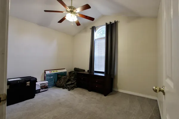a bedroom with a bed and a ceiling fan