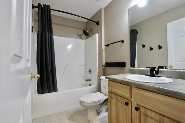 a bathroom with a sink a toilet and a mirror
