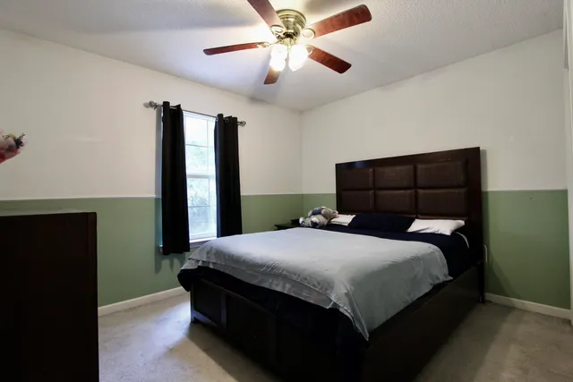 a bedroom with a bed and a chandelier