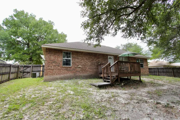 a view of a small house with a yard