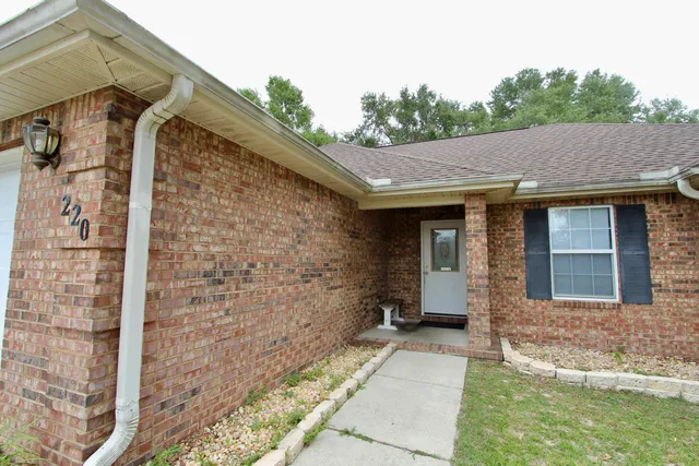 a view of house with backyard