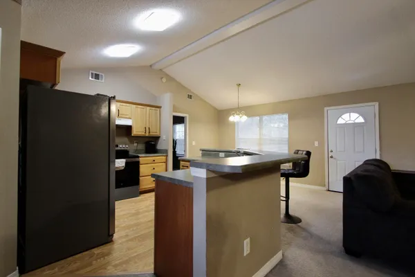 a kitchen with counter top space and refrigerator