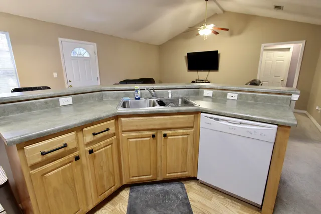 a kitchen with cabinets appliances and a sink