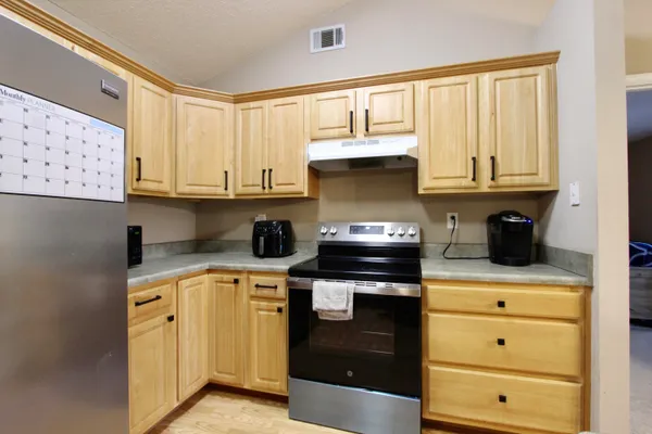 a kitchen with stainless steel appliances granite countertop a stove and a microwave