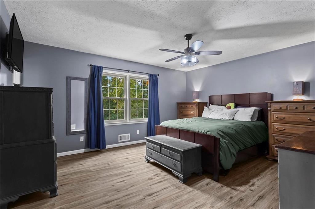 4593 Mars Court Acworth, GA 30101 - Photo 11 of 19 a bedroom with a bed and a flat screen tv