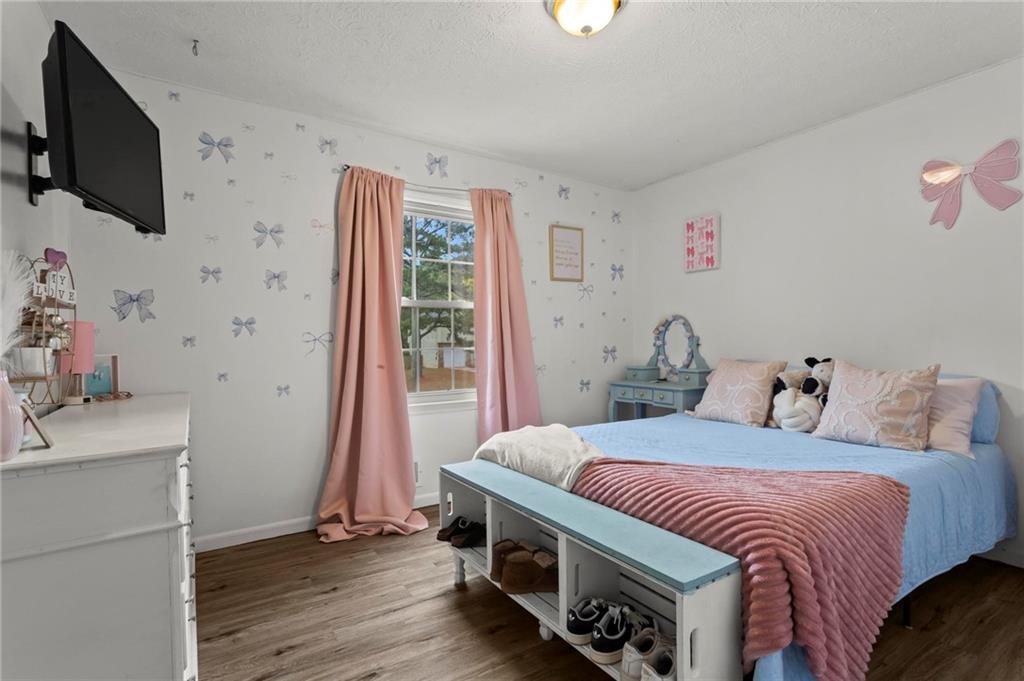 4593 Mars Court Acworth, GA 30101 - Photo 13 of 19 a bedroom with a bed and a flat screen tv