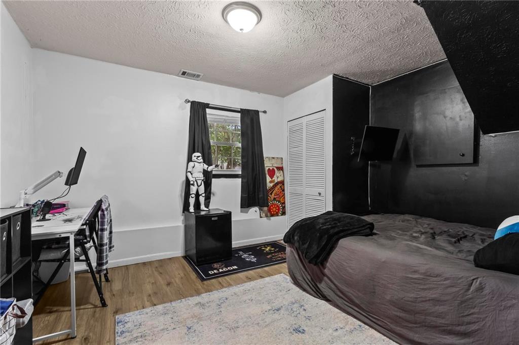 4593 Mars Court Acworth, GA 30101 - Photo 14 of 19 a bedroom with a bed and a table in it