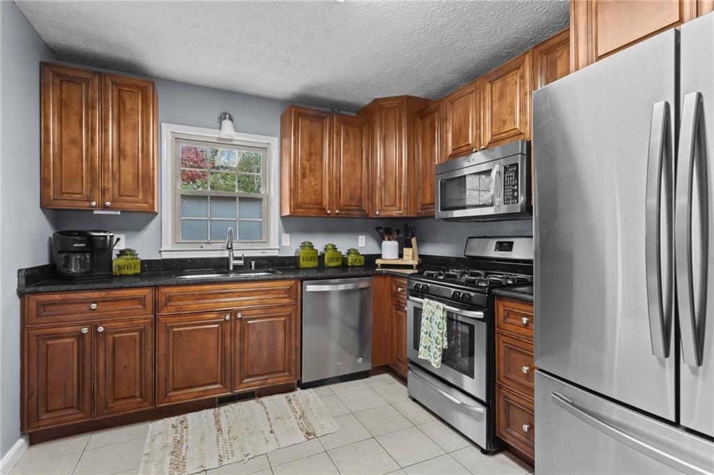 4593 Mars Court Acworth, GA 30101 - Photo 6 of 19 a kitchen with stainless steel appliances granite countertop a refrigerator and a sink