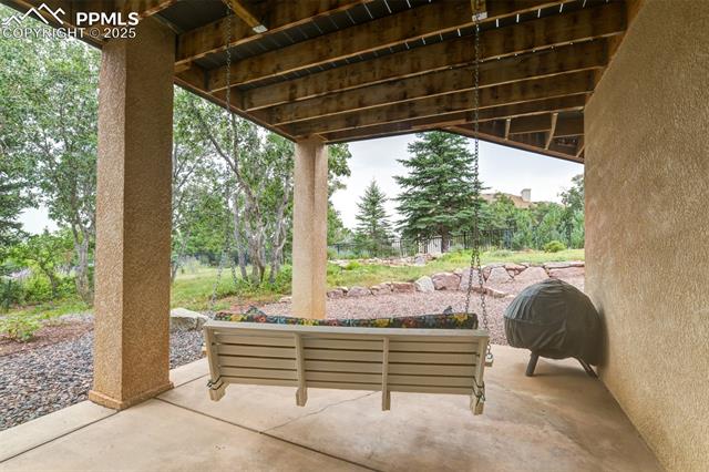 6240 Wilson Road Colorado Springs, CO 80919 - Photo 38 of 42 Lower level covered patio with a direct view of the ornamental pond.