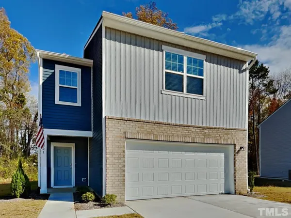 a front view of a house with garage
