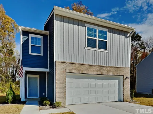 a front view of a house with garage