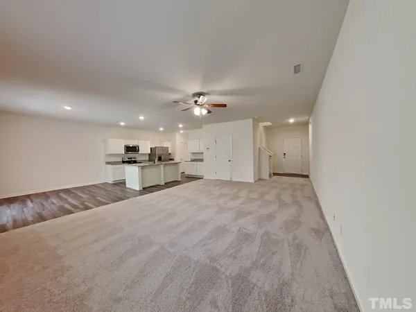 a view of kitchen and hall with wooden floor