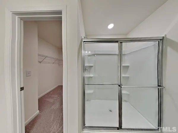 a bathroom with a glass shower door