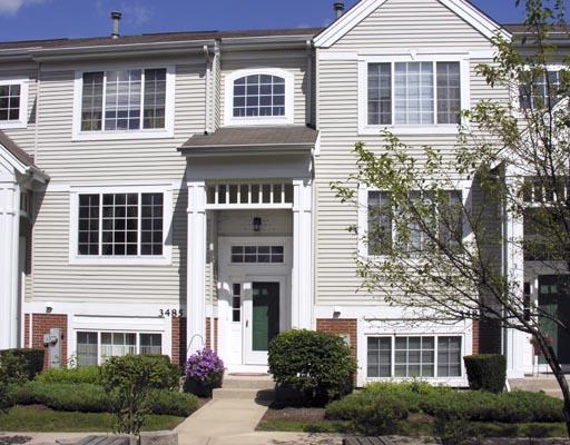 3485 Ravinia Circle, Unit 153 Aurora, IL 60504 - Photo 1 of 1 a front view of a house with a yard