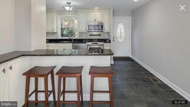 a kitchen with stainless steel appliances granite countertop a stove top oven a sink and dishwasher