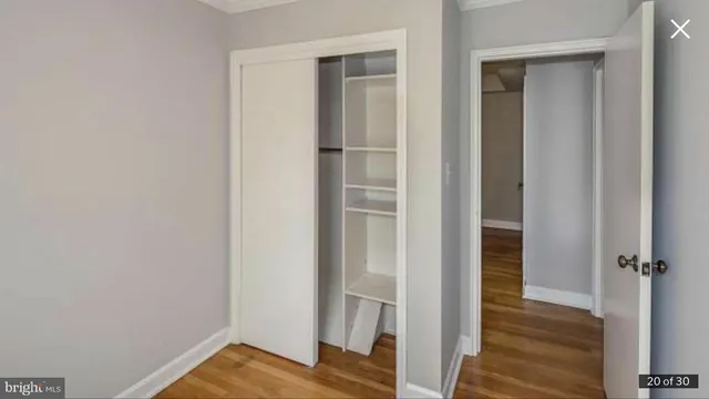 a view of walk in closet with wooden floor