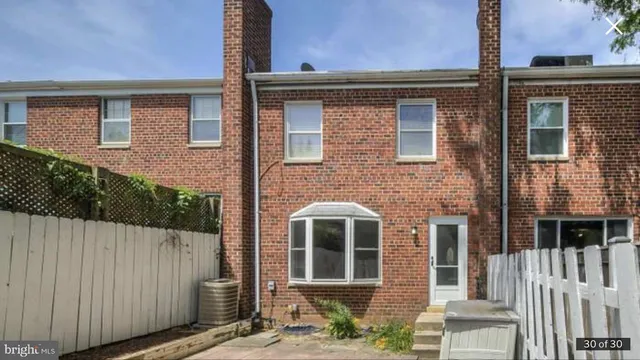 a front view of a house with a fence
