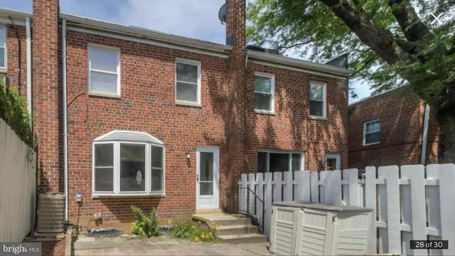 a front view of a house with iron fence