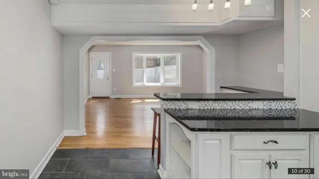 a bathroom with a granite countertop sink and window
