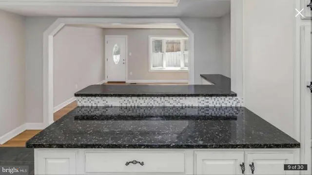 a living room with kitchen island