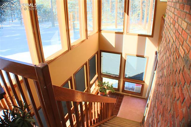 2465 Evergreen Road Colorado Springs, CO 80921 - Photo 8 of 25 Stunning staircase & sun room area