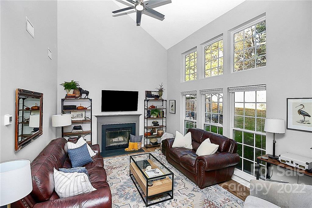 12403 Old Timber Road Charlotte, NC 28269 - Photo 11 of 33 a living room with furniture a flat screen tv and a fireplace