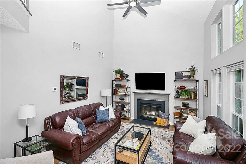 12403 Old Timber Road Charlotte, NC 28269 - Photo 12 of 33 a living room with furniture a flat screen tv and a fireplace