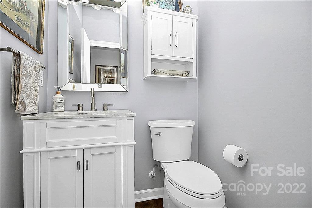 12403 Old Timber Road Charlotte, NC 28269 - Photo 14 of 33 a bathroom with a toilet sink vanity and mirror