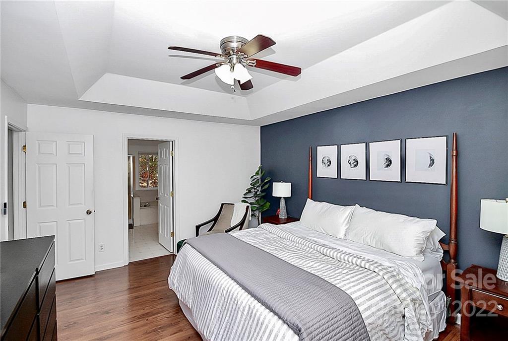12403 Old Timber Road Charlotte, NC 28269 - Photo 17 of 33 a bedroom with a bed and wooden floor
