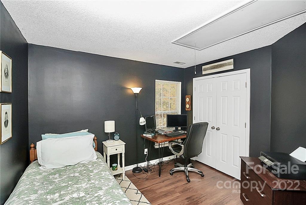 12403 Old Timber Road Charlotte, NC 28269 - Photo 19 of 33 a workspace with furniture and a wooden floor