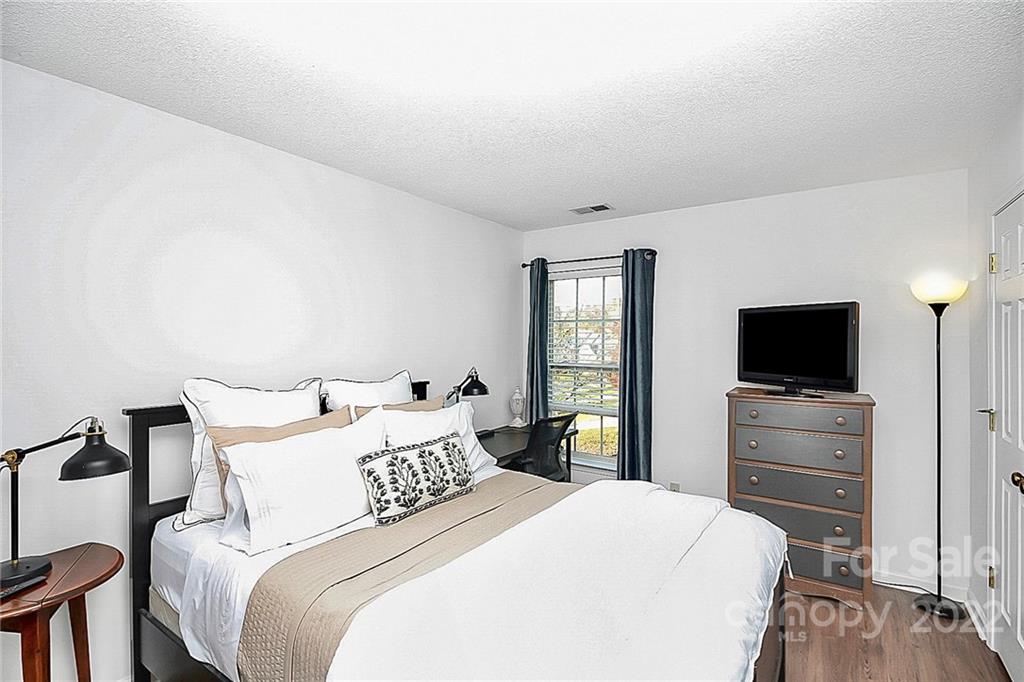 12403 Old Timber Road Charlotte, NC 28269 - Photo 22 of 33 a bedroom with a bed and a flat screen tv