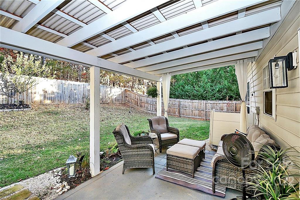 12403 Old Timber Road Charlotte, NC 28269 - Photo 29 of 33 a balcony with furniture and a garden