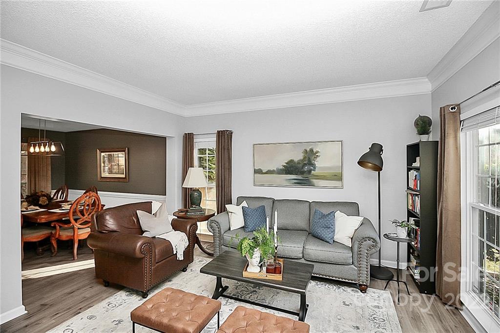 12403 Old Timber Road Charlotte, NC 28269 - Photo 3 of 33 a living room with furniture and wooden floor