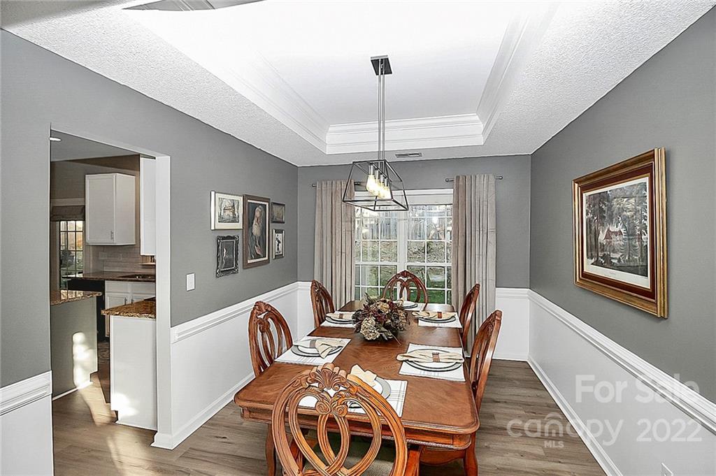 12403 Old Timber Road Charlotte, NC 28269 - Photo 5 of 33 a view of a dining room with furniture window and wooden floor