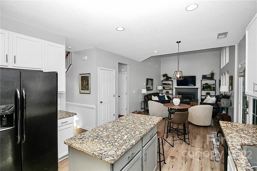 12403 Old Timber Road Charlotte, NC 28269 - Photo 6 of 33 a kitchen with stainless steel appliances kitchen island granite countertop a refrigerator and microwave