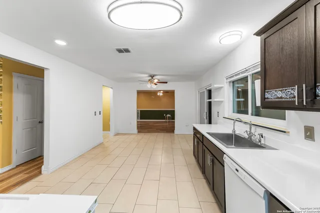 a spacious bathroom with a double vanity sink and a mirror