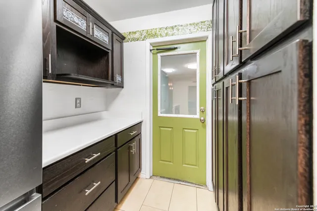 a kitchen with a refrigerator and a sink