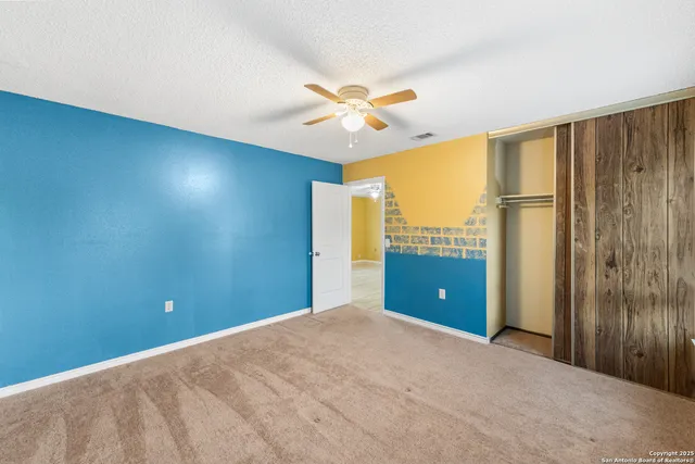 a view of a livingroom with a ceiling fan and window