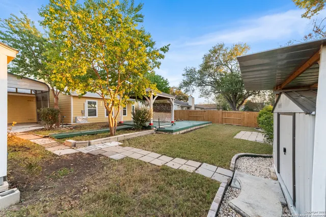 a view of a backyard with table and chairs and a fire pit
