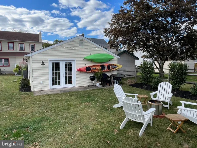 a view of a house with a yard and sitting area