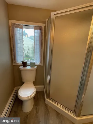 a bathroom with a toilet and a shower