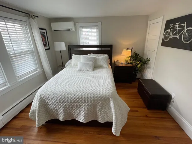 a bed sitting in a bedroom next to a window
